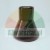 Dark brown or black hourglass-shaped technical component, flared at the base, showing a visible textured surface, against a light background.