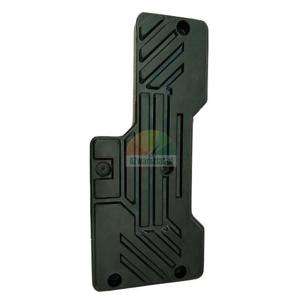 Dark, rectangular plastic or rubber component with geometric grooves and four mounting holes, resembling a technical cover or pad.