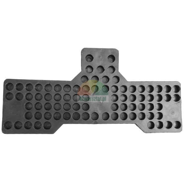 Dark T-shaped rubber or plastic element covered with numerous circular indentations or holes, likely used as an anti-vibration pad or connecting component.
