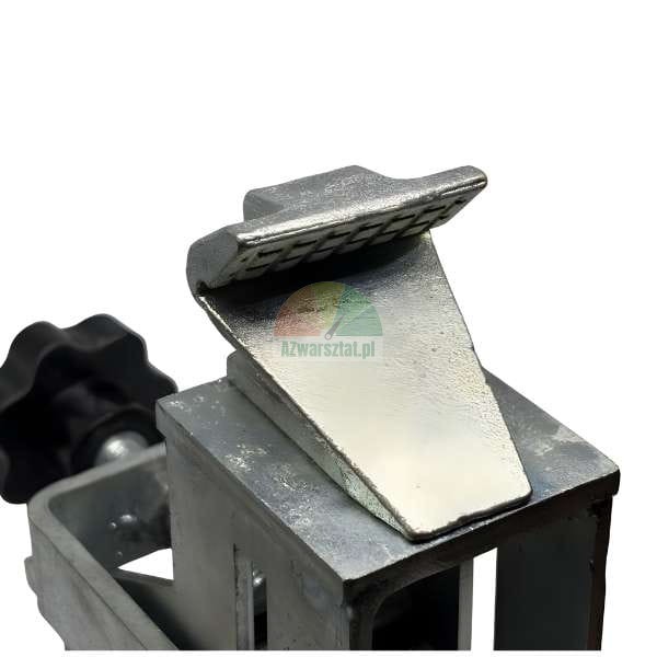 Close-up of a galvanized metal clamping wedge or press tool component mounted on a square frame, with a black adjustment knob visible on the left.