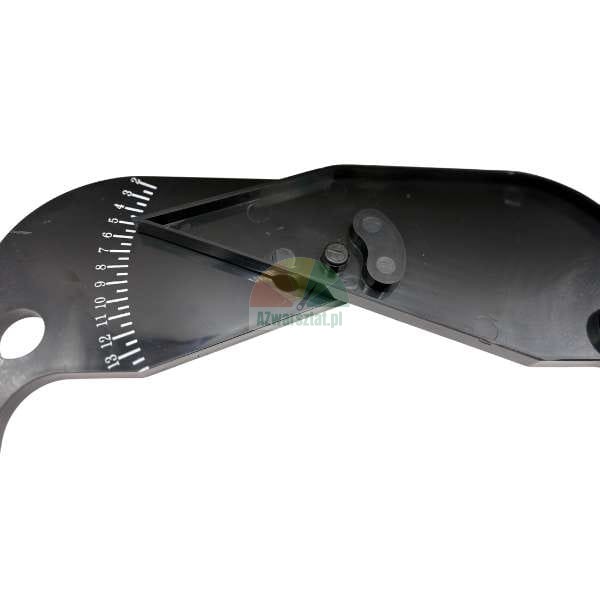 Close-up of a black hinged tool, possibly an angle cutter or protractor, featuring a white measurement scale numbered 1 to 13.