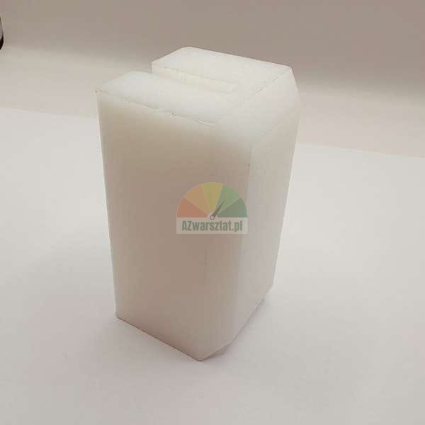 White plastic block with a groove on top.