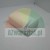 White melamine sponge in the shape of a rectangular block on a light background.