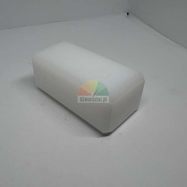 White melamine sponge in the shape of a rectangular block on a light background.