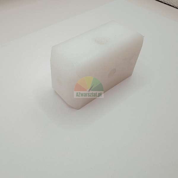White rectangular plastic block on a light background.