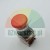 Red emergency stop mushroom button with arrows on top showing rotation direction.