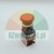 Red industrial emergency stop mushroom button with electrical mounting block on a white background