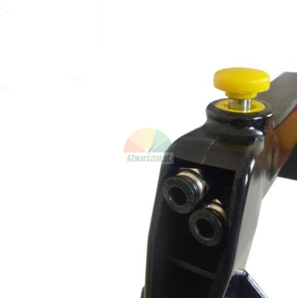 Close-up of a black mechanical component with a yellow button and two mounting holes on a white background