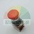 Red emergency stop button with visible contact block and reset arrows on a gray background.