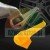Metal tire changer mount demount head with a yellow plastic protector insert against a car wheel background.