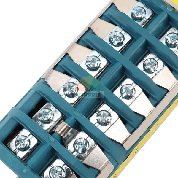 Close-up of an electrical terminal block with metal screws and a teal plastic base for wiring connections.