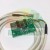 Green printed circuit board YT-DA1 with electronic components, sensors, and a white cable with a connector.