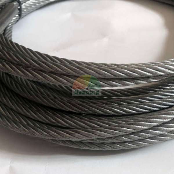Close-up of a coiled steel wire rope showing detailed twisted strands on a white surface.