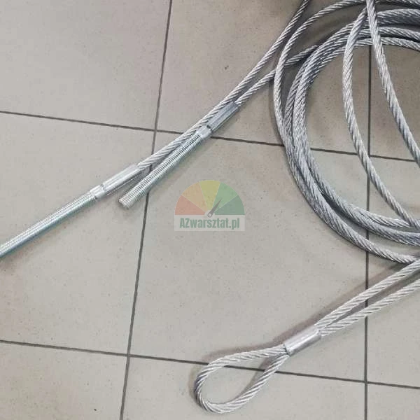 Steel wire rope with threaded terminals and a loop, placed on grey floor tiles.