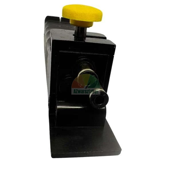 Black industrial pneumatic component with yellow knob and two circular connection ports