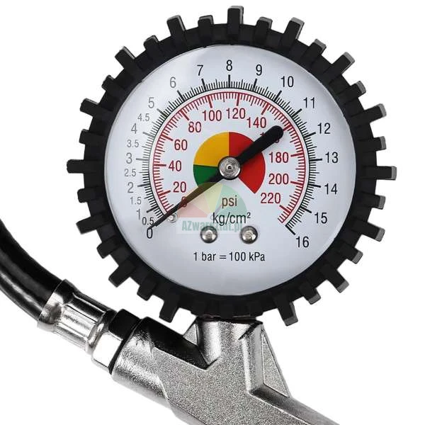 Pressure gauge on a tire inflator gun with dual scale showing psi and bar readings.
