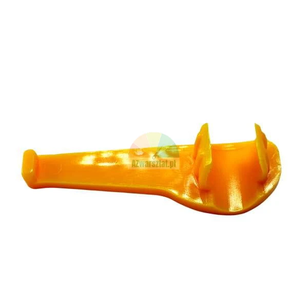 Orange plastic key for removing child safety socket covers on a white background