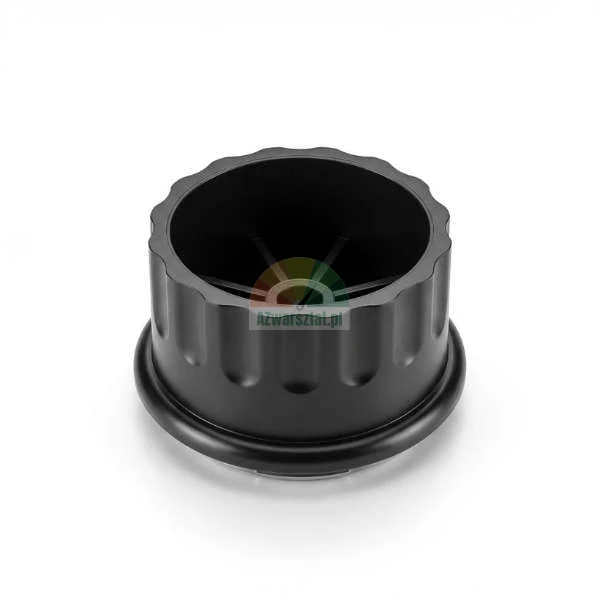 Black plastic cylindrical part with a fluted outer surface and internal spoke structure on a white background.