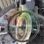 Close-up of a disassembled mechanical component with a metal disc and shaft surrounded by tools in a workshop
