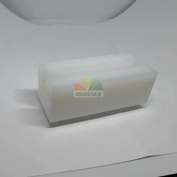 White plastic rectangular block with a longitudinal groove on a white background.