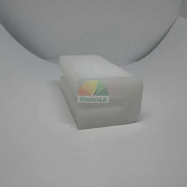 White plastic component with a C-shaped profile on a light background.