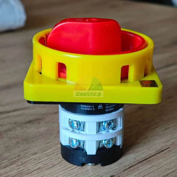 Rotary main switch with a red handle and yellow housing, emergency stop industrial switch.
