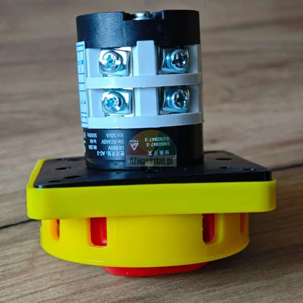 Industrial rotary cam switch with a yellow housing and black terminal block featuring visible screw terminals and technical specifications.