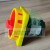 Industrial emergency stop rotary switch with red handle and yellow housing