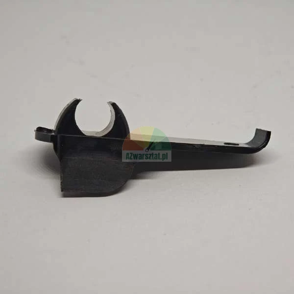 Black plastic spare part, likely a latch or lever for a household appliance, on a light background.