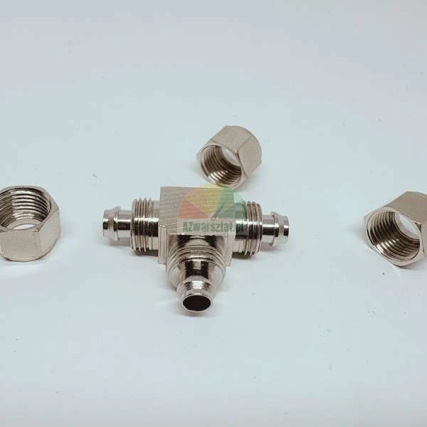 Metal hydraulic T-fitting with three hexagonal nuts on a white background.