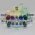 White pneumatic manifold block with blue push-to-connect fittings and indicated dimensions of 4mm, 6mm, 8mm, and 10mm.