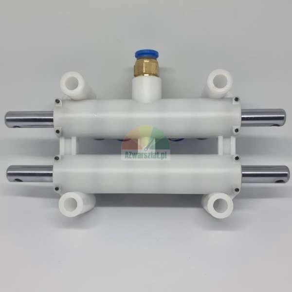 White plastic pneumatic manifold with metal rods and a brass fitting on a light background.