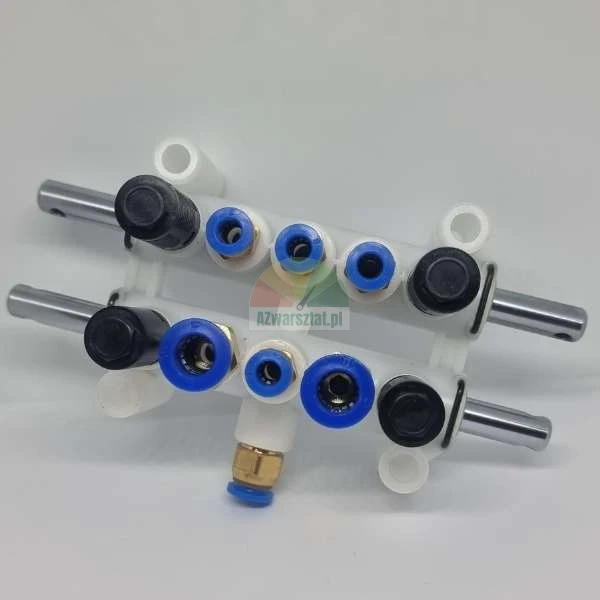 Pneumatic manifold with blue quick-connect fittings and black valves on a white body