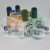 Pneumatic manifold valve block with brass fittings blue push-in rings and black silencers on white background