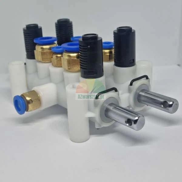 Pneumatic manifold valve block with brass fittings blue push-in rings and black silencers on white background