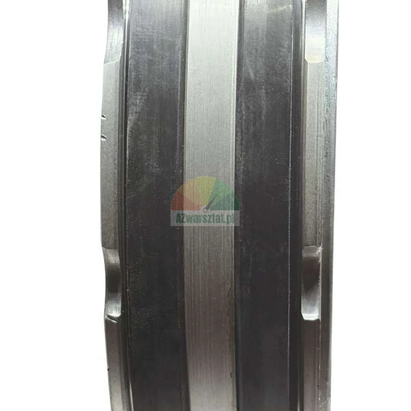 Close-up of a cylindrical metal part with alternating silver and black grooves.