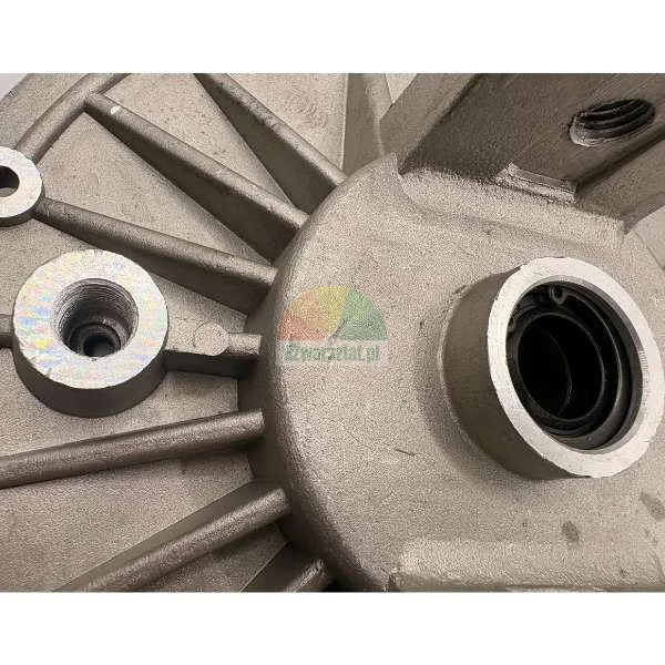 Close-up of a metal cast component with cooling ribs and a central bearing housing