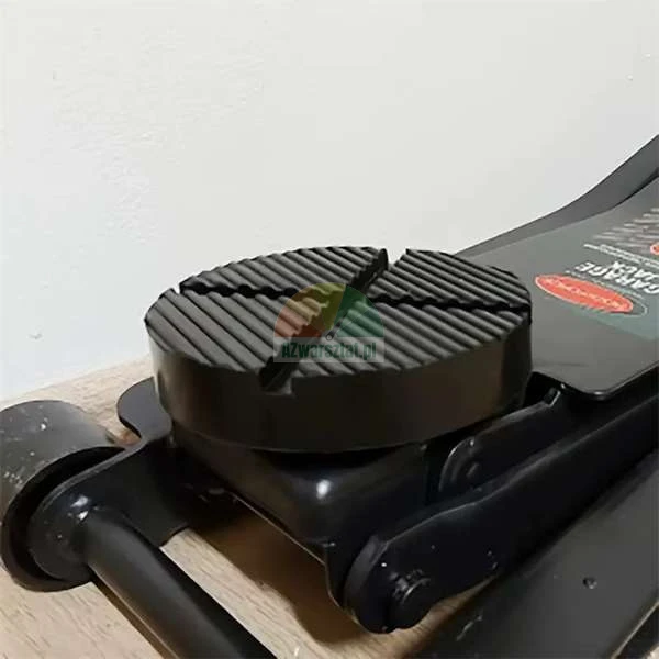 Black rubber jack pad for a floor jack with a non-slip grooved surface.