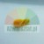 Small yellow plastic component or spare part on a plain light background.