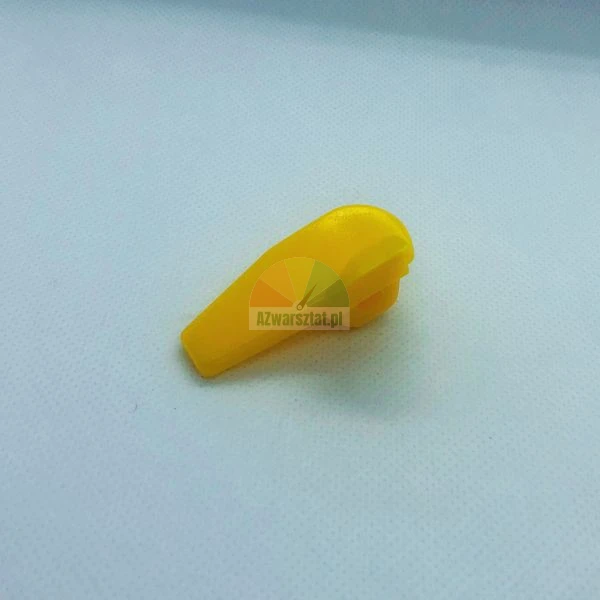 Small yellow plastic lever or paddle component on a light background.