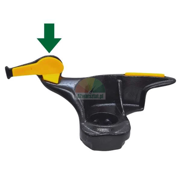 Metal tire changer mount head with a green arrow pointing to the front yellow plastic insert.