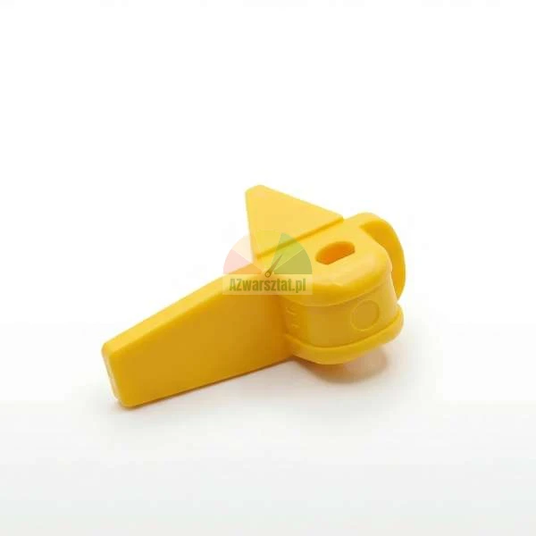 Yellow plastic latch component or safety lock for industrial applications.