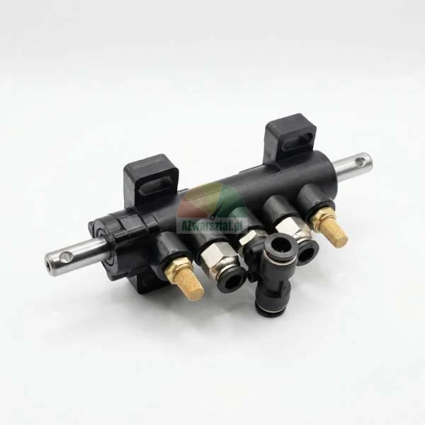 Black pneumatic manifold block with metal fittings and brass silencers on a white background.