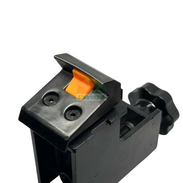Black T-track flip stop with an orange plastic lever and a star-shaped adjustment knob.