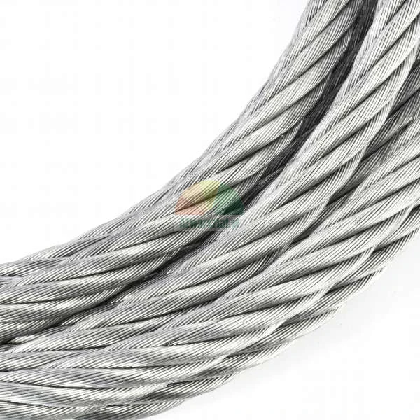 Close-up of a strong steel wire rope coiled on a white background.