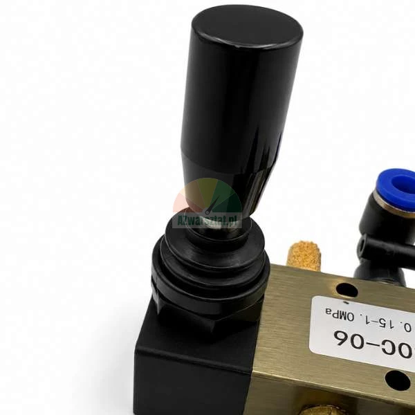 Black hand lever of a pneumatic control valve on a brass body with a model label.
