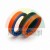 Compact piston seal consisting of orange, blue, and black sealing elements on a white background.