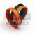 Three colorful hydraulic seals (orange, blue, and black) arranged together on a white background.