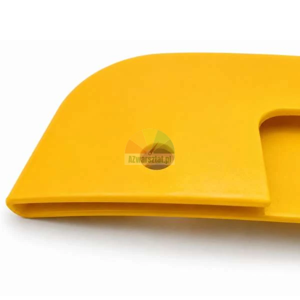 Close-up of a yellow plastic protective element with a rounded edge and a mounting hole.