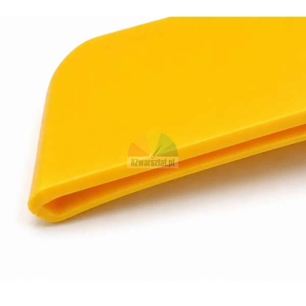 Close-up of the edge of a yellow plastic squeegee on a white background.